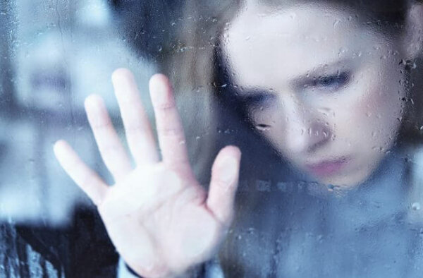 A woman behind a glass.