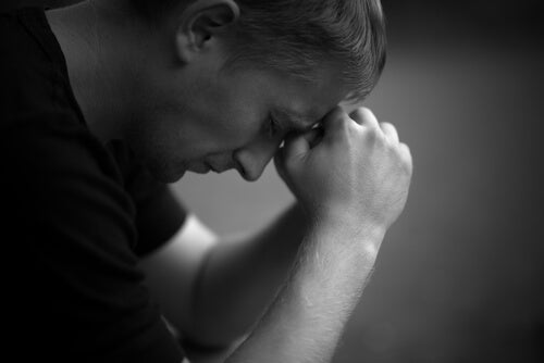 Man feeling depressed, representing the color gray and depression.