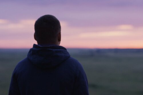 A man with anticipatory nostalgia feeling sad while looking into the horizon.