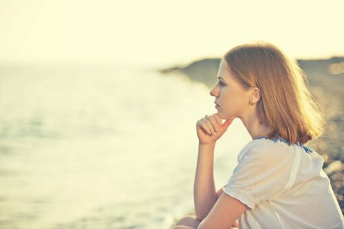 A woman looking at the ocean.