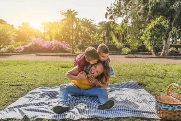 A woman playing with two children.