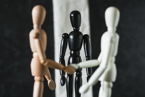 Two dummies shaking hands while a third one is just there.