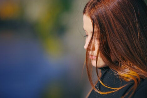 A worried woman looking down.
