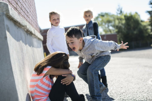 A bully screaming at a child at school.