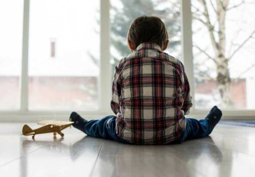 A boy with emotionally unavailable parents playing by himself.