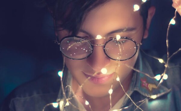 A boy with lights around his face.