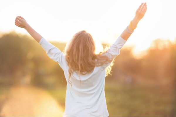 A woman holding her arms up.