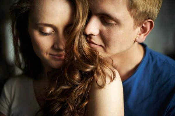 A man inhaling the smell of his partner.