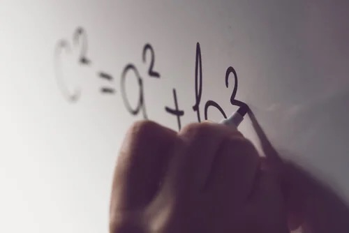 Writing math on a whiteboard.