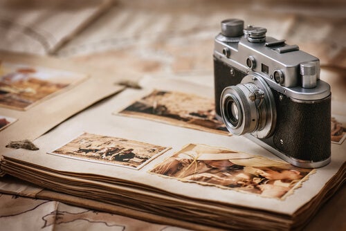 A camera over a photo album.