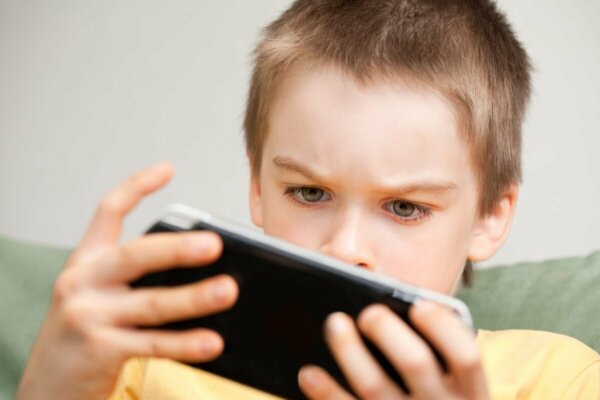 A child looking at a phone.