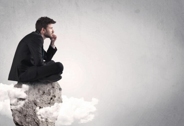 A man sitting on a rock.