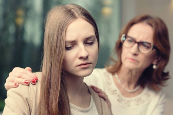 A woman comforting another.