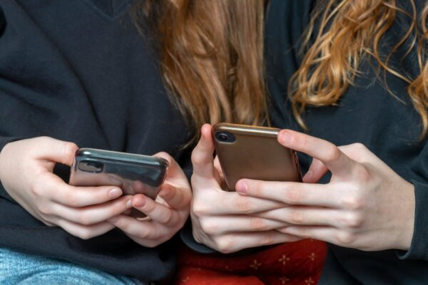 Two people using their phones.