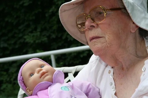 A woman experiencing doll therapy.