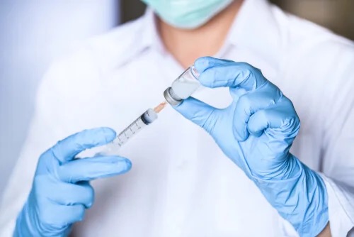 A medic holding a vaccine.