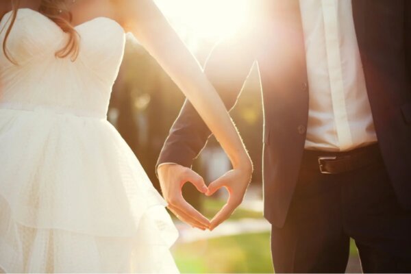A bride and groom holding hands.
