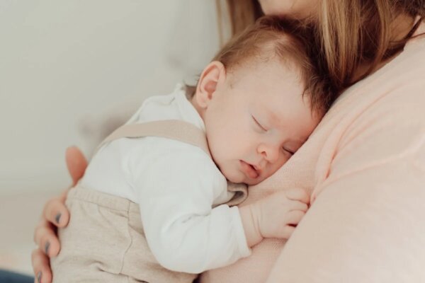 A mother holding her baby.