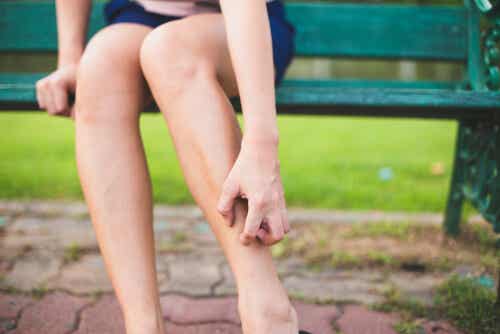 A woman scratching her leg.