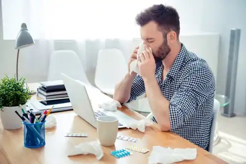 A man blowing his nose.