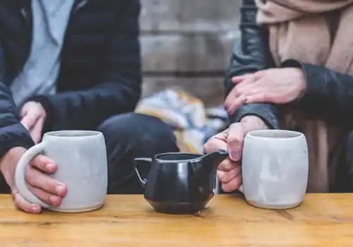 A couple sharing a coffee together, maybe sharing feelings.