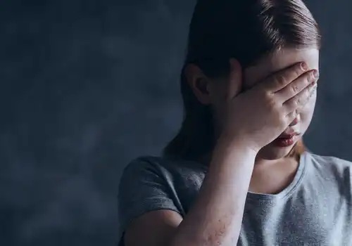 A distressed girl, maybe experiencing social rejection.