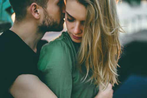 A man kissing a woman.