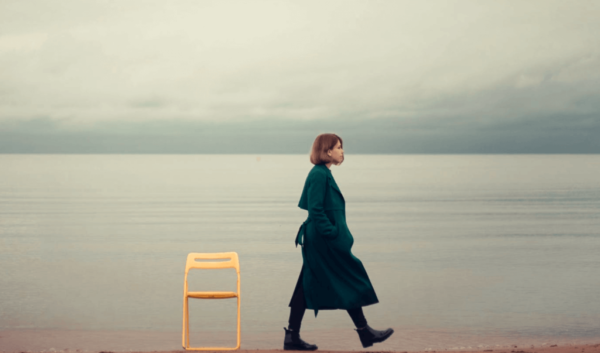 Vrouw loopt weg bij een stoel op het strand
