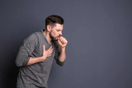 An image of man coughing, maybe he has factitious disorder.