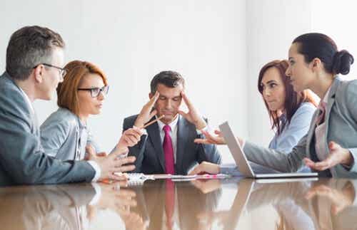 A stressed man in a meeting.