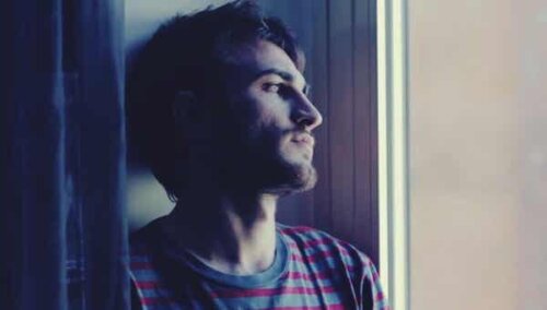 A man staring maybe due to shyness.