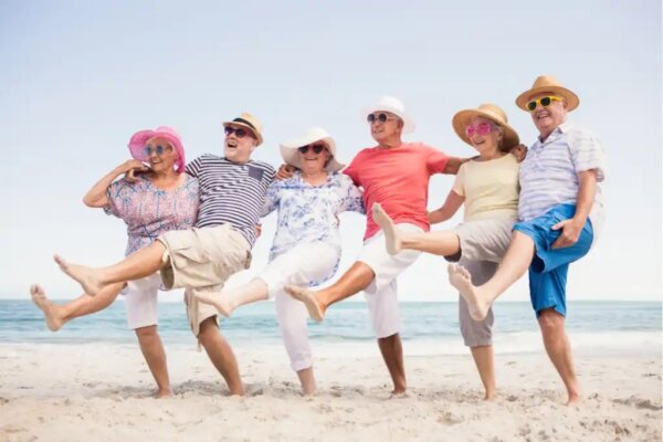 A group of elderly people having fun on the beach.