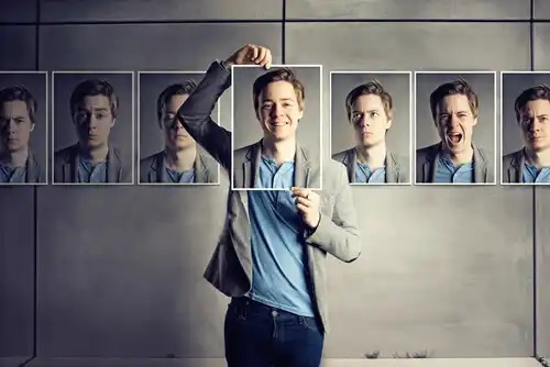 A man holding up different photos of himself.
