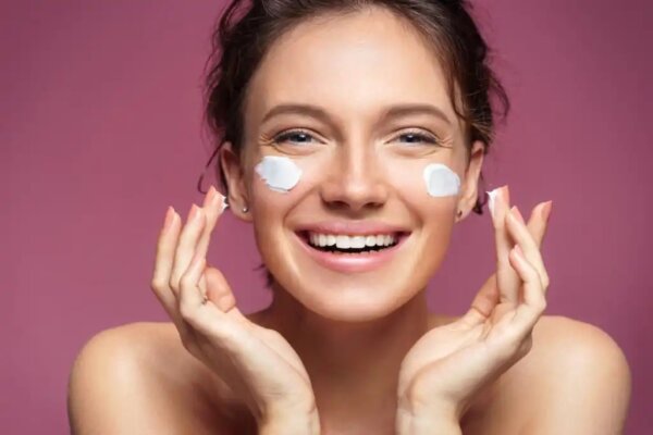 A woman perhaps putting neurocosmetic cream on her face.
