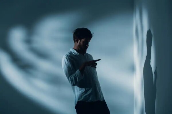 A man looking at his shadow.