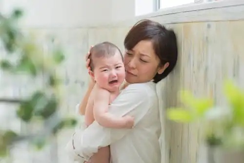 A mother with a crying baby.