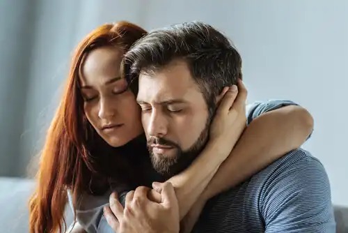 A couple holding each other.