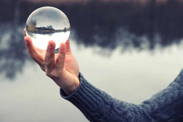 A person holding a glass ball.