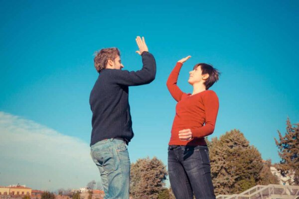 Two people high-fiving.