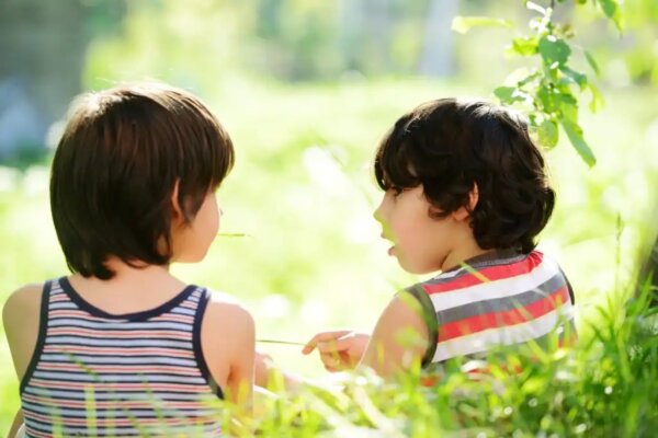 Two young boys talking.