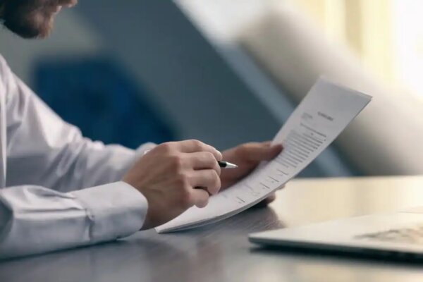 A man completing a form.