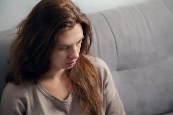 A sad woman, perhaps suffering family trauma.