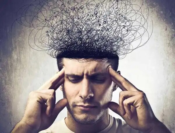 A man with tangled wires for a brain, suggesting limiting beliefs.