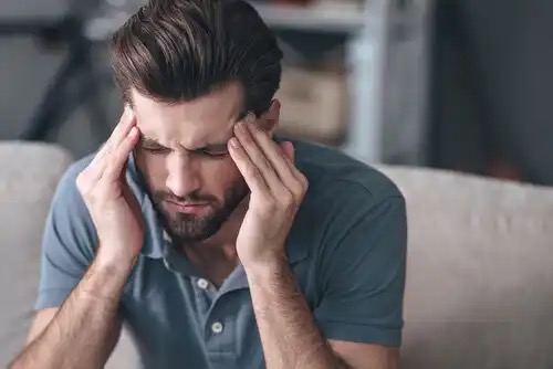 A man with a headache.