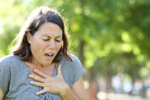 A woman with her hand on her chest during an anxiety attack.