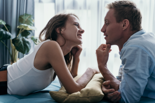 A man and woman looking at eachother face to face and talking.